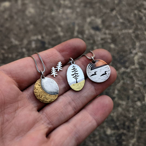 Loons on the lake - mixed metal loon wildlife pendant necklace