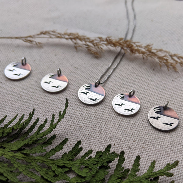 Loons on the lake - mixed metal loon wildlife pendant necklace